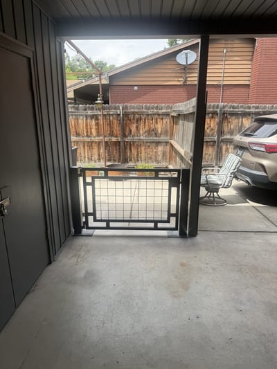 Black steel pedestrian gate with mesh infill panel — view 2.