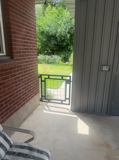 Black steel pedestrian gate with mesh infill panel — view 3.