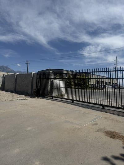 Black steel automated sliding driveway gate.