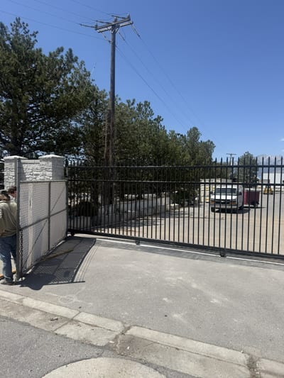 Black steel automated sliding driveway gate — view 2.