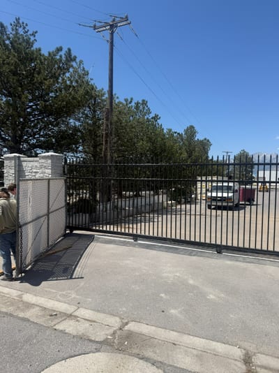 Black steel automated sliding driveway gate — view 2.