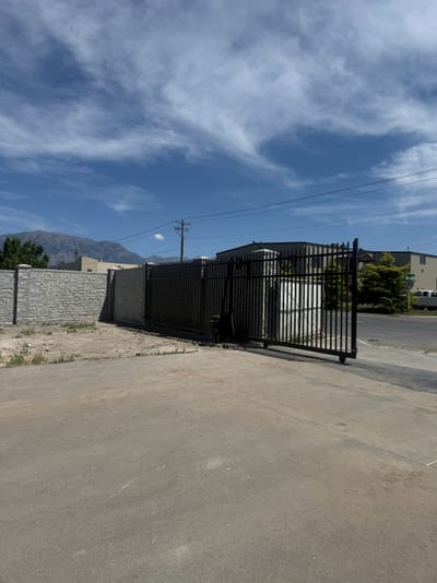 Black steel automated sliding driveway gate — view 3.