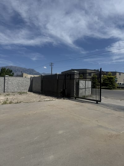 Black steel automated sliding driveway gate — view 3.