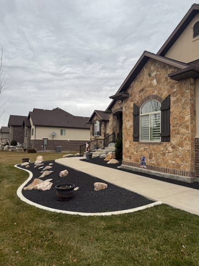 Dark bronze steel stairway railing on stone entry steps — view 2.