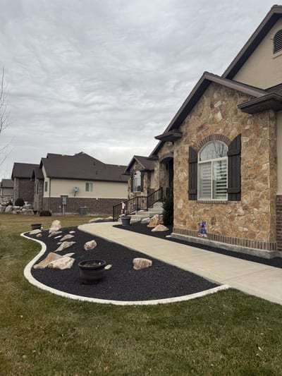 Dark bronze steel stairway railing on stone entry steps — view 2.